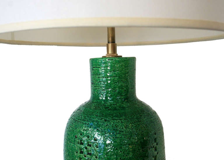 Matched pair of ceramic table lamps by Bitossi, Italy, circa1950's. Incised patterned ceramic bases with kelly green coloring.Newly restored with bronze double cluster fixture and brown silk cording.Lamp bases are 4 sided, not round in shape.
This