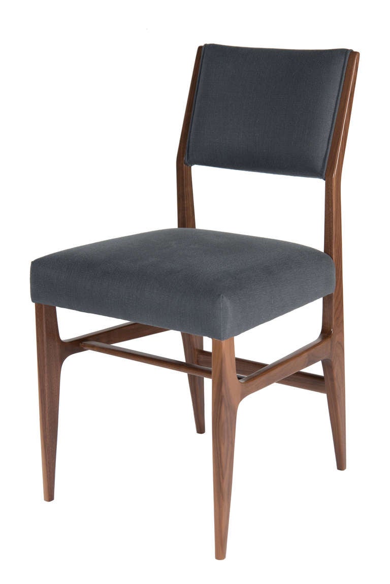 Walnut dining chair upholstered in a natural cotton fabric.

Seat height-19".
Seat depth -17".
COM requirements: 1.5 yards. 
5% up-charge for contrasting fabrics and or welting. 
COL requirements:30 sq. feet. 
5% percentage