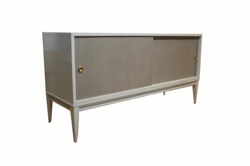 Mn Originals lacquered console on solid maple tapered leg frame with natural linen doors which have been colored and polished detailed with solid brass finger pulls. Interior adjustable shelves, the piece is low profile to facilitate a flat screen