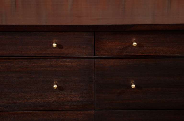 Paul McCobb Calvin 8 Drawer Dresser For Directional circa 1950's.Finely constructed modernist dresser from mahogany with solid brass X cross stretcher detail and original drawer hardware.Fully restored in a dark brown open grain satin
