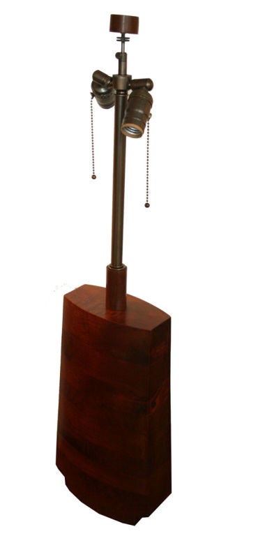 Solid walnut table lamp, circa 1970s with newly added double cluster bronze fixture topped with original solid walnut turned finial. Solid walnut blocking shaped in a tapered form with convex front and back faces.