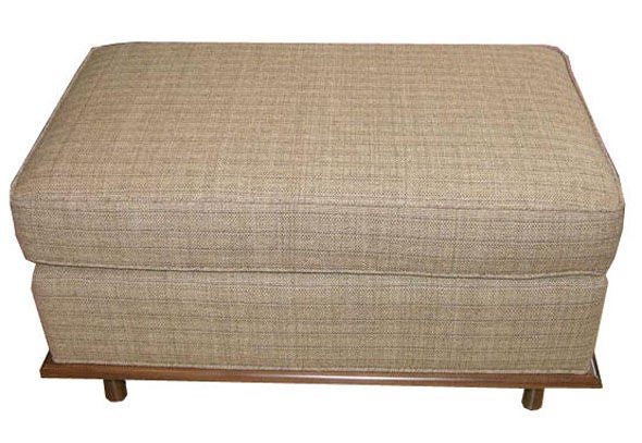 Mn Originals walnut skirted-base ottoman made to order. 

COM requirements: 3 yards. 
5% up-charge for contrasting fabrics and or welting.
COL Requirements: 60 sq. feet. 
5% percentage up-charge for all COL or exotic materials.

Custom orders
