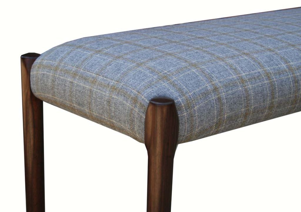 Niels Moller solid rosewood bench restored with wool plaid upholstery.Simple and elegant rosewood legs detail the seamless upholstery bench top.