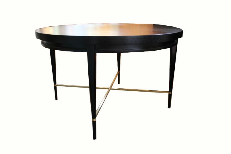 Paul Mccobb 8907 mahoghany dining table for Directional in newly restored ebony open active grain satin finish.Table is og high quality and is in mint condition with original solid brass square profile X shape lower stretcher.Table has 2 original