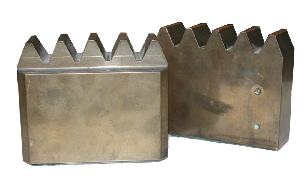 Heavy weight solid brass machined bookends with a bronze exterior patina.