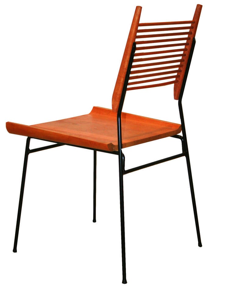 Paul McCobb maple and Iron shovel chairs Ca. 1950s in restored condition.Solid sculpted maple seat with turned spindle back supports on iron framework.

Paul McCobb (1917-1969) is an American designer best known for the Planner Group, his