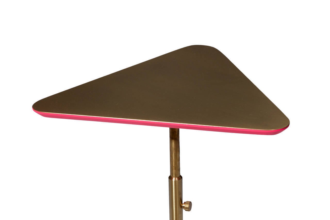 Pyramid Marble base cocktail table with telescoping swivel post supporting satin brass top with lacquered underside.
Designed by Ben Erickson for Erickson Aesthetics .

Custom orders have a lead time of 10-12 weeks FOB NYC. Lead time contingent upon