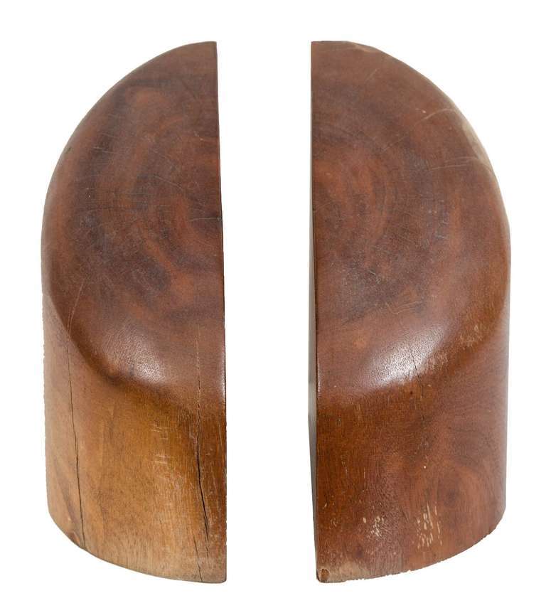 Pair of signed Don Shoemaker solid rosewood bookends, circa 1970 in original condition. Heavy organic solid rosewood with natural sap detailing. Original paper label remnant on bottom.