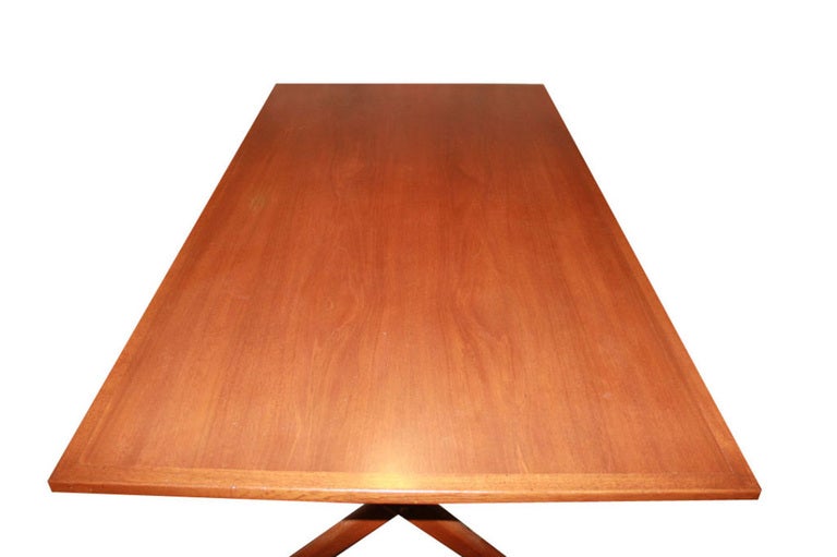 Early Hans Wegner for Andreeas Tuck X-base teak trestle table circa 1960s with original burned stamp. Metal support rods detail the structure of the base while the solid edged top floats nicely over solid X-supports. Table is perfect for six people