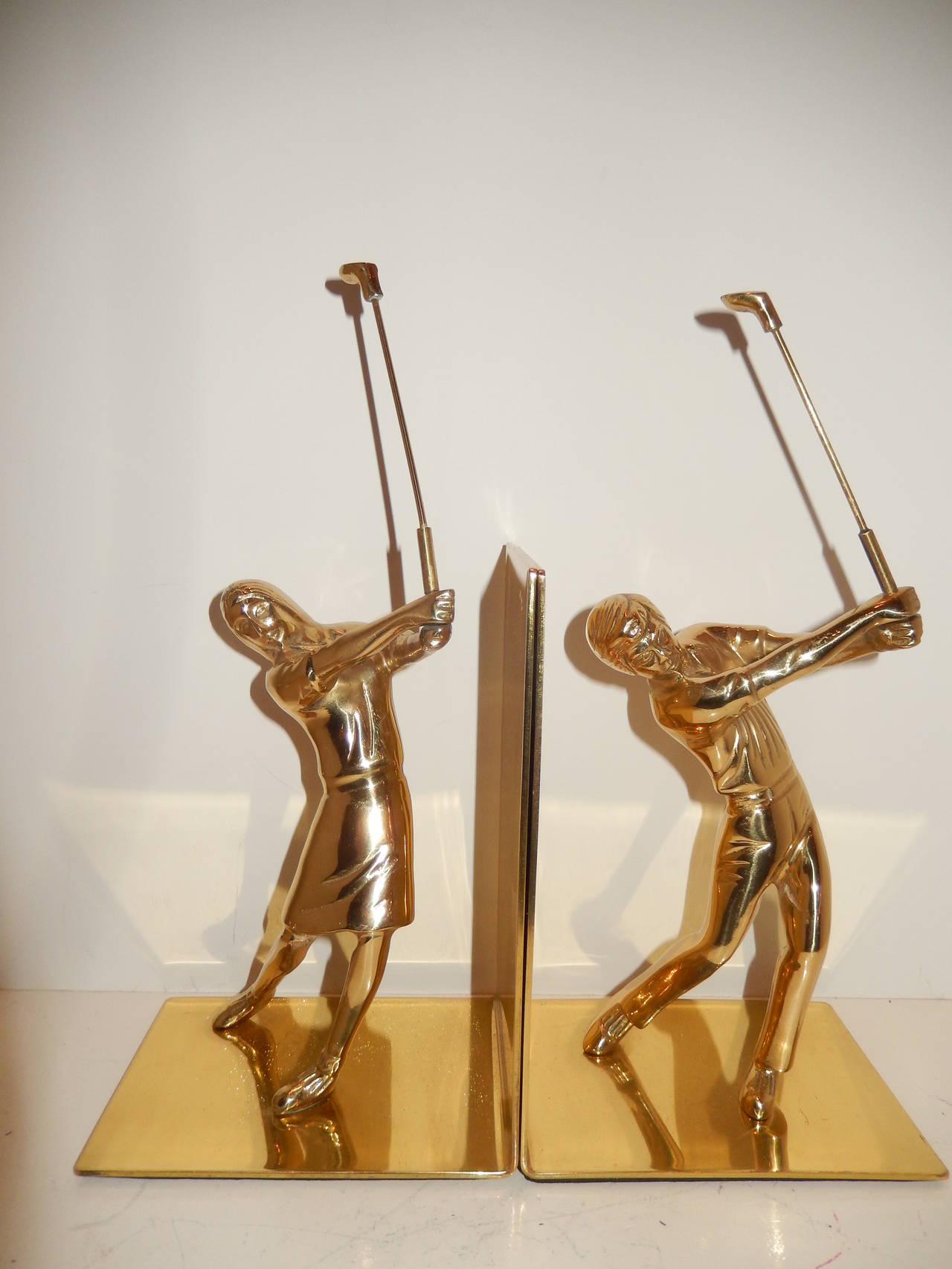 Pair of solid brass well detailed bookends. Sporting golf attire from the 1920s, wonderful condition with good weight (for book support).