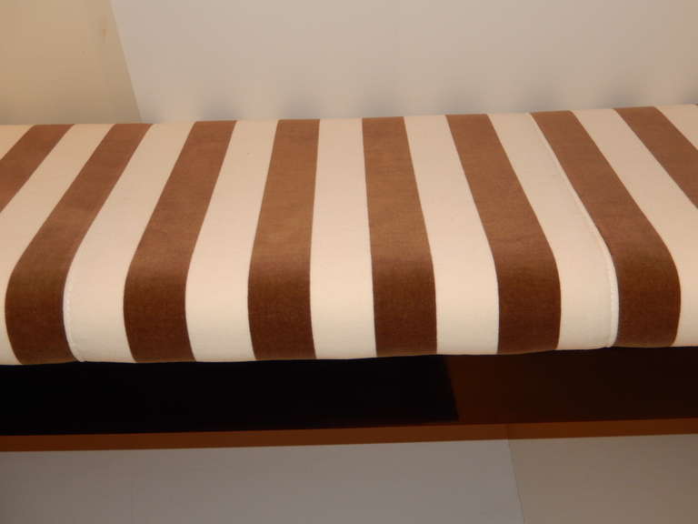 A stunning hand crafted Mont style upholstered bench. Made of birch woods and finished with a deep mahogany brown high lacquer finish. The seat is upholstered in a soft velvet brown and cream striped fabric, a truly elegant piece, for any setting.