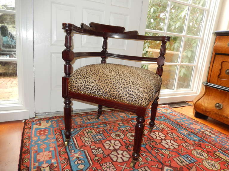 Upholstered in a tapestry leopard print premium fabric, this late 19thc corner chair would be a creative addition to any room. Mahogany wood frame with brass caster feet.