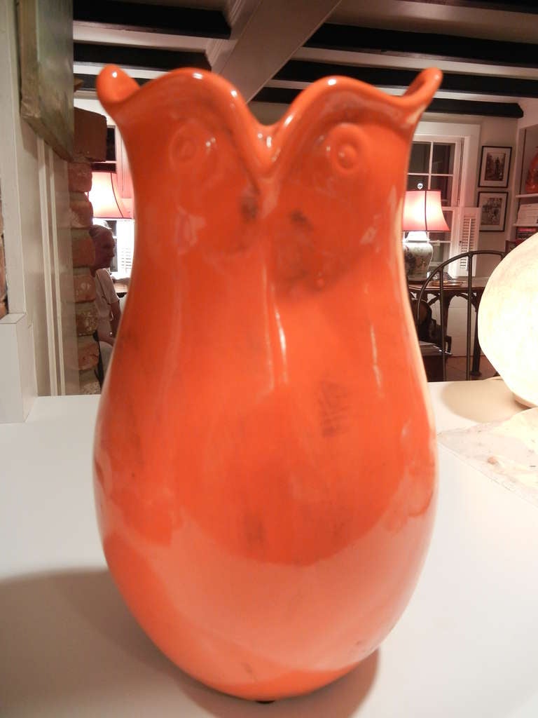 A tall owl faced  studio crafted, bright orange Mid-Century pottery vase from England ,wonderful condition,there is no paint loss or chips.