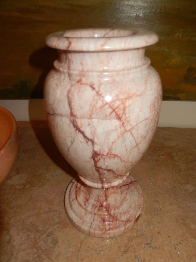 A fine and well detailed pair of pink rose marble urns/vases. Excellent condition without cracks or loss. Perfect for a mantel,or center piece.