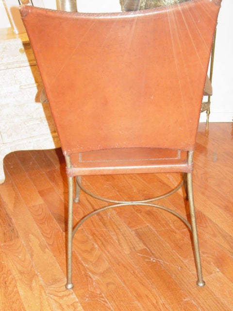 Six Mid-Century Italian leather & Iron Chairs.Rich tan leather with etched detailing on seats and top back rest corner's,top quality leather nicely worn.The iron has a bronze patina) scrolled arms and crescent shaped cross bars.Six lovely chairs.