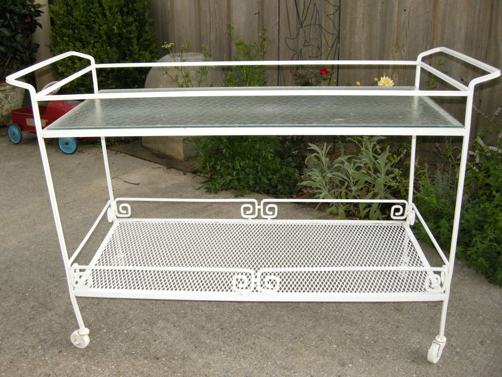 Extra large two level garden cart.Frosted glass top,open mesh work bottom,solid construction with decorative iron work. Caster's.