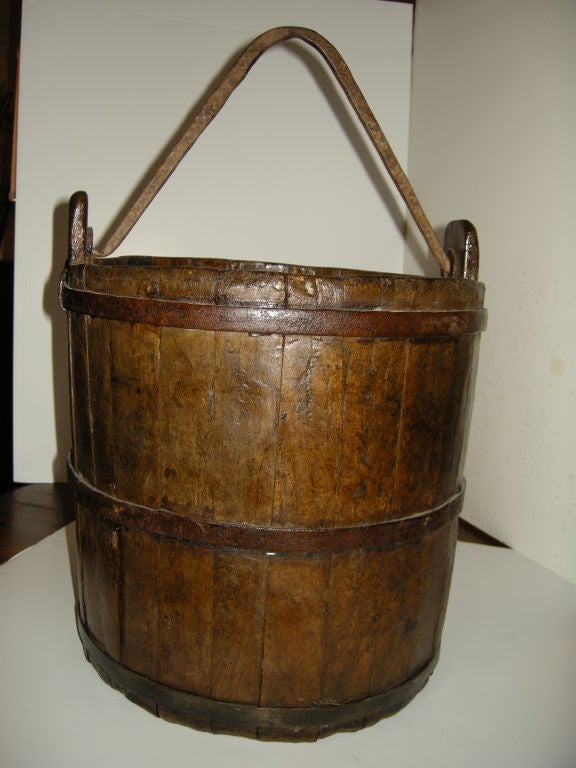 Large Antique  Walnut Wood bucket/pail. Great for the fireplace. Other uses,magazine holder,planter,dried flowers. Walnut wood with iron trim and v shaped handle.