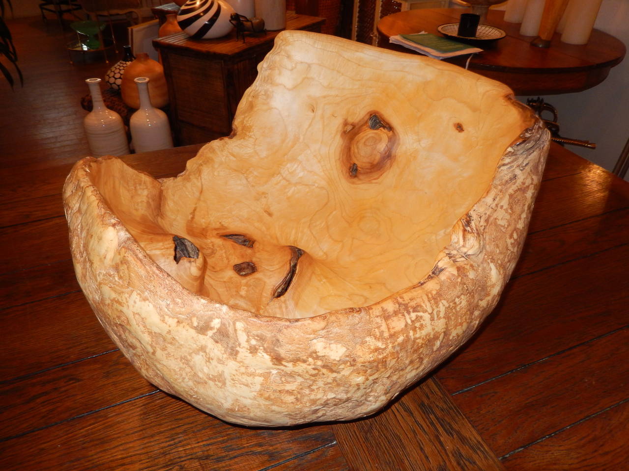 An extraordinary free-form large maple and burl wood vessel. At its highest point the bowl measures 14 inches high and at its lowest 6 inches high.
The unique form liken to a cracked egg. A wonderful center piece for any environment.