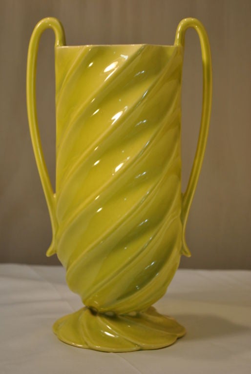 A magnificent and unusual Red Wing Vase. Eye catching bright chartreuse green, with swirled body to base, fragile handles. Base marked Red Wing number 1376.
