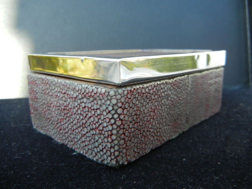 A vintage Shagreen & Sterling Silver trinket box.The box has a glass top,to protect a small piece of Peruvian Antique hand woven fabric. Well crafted mahogany wood interior.