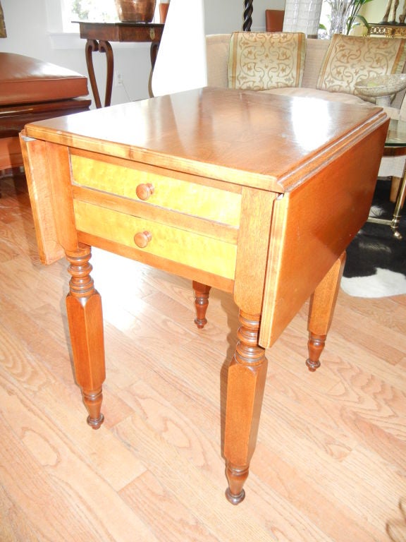 A lovely American (New York) drop leaf two drawer serving table or end table. Solid cherry wood frame, birdseye maple drawers. Two sided drop leaves, extends to 44 inches.