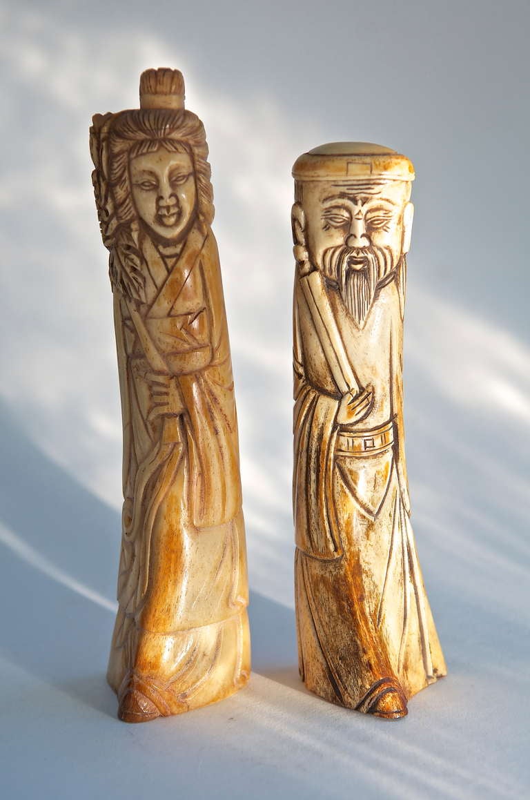 A Chinese male and female hand carved ox bone figures. Late 19th century. Measurements shown are for the female. The male sculpture is 8