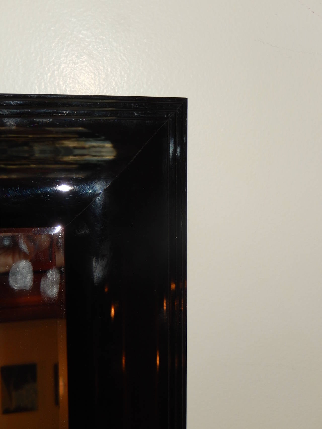 A black lacquered free standing floor mirror (ready to hang) excellent condition, original beveled glass, silver backed.