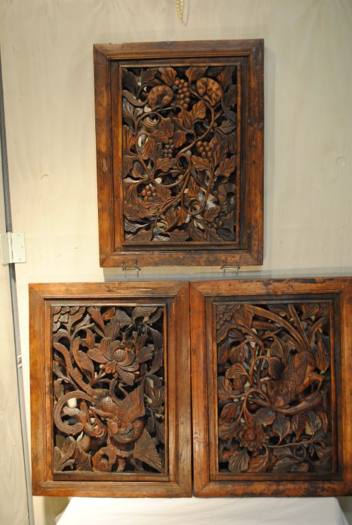 Three gorgeous wooden panels with raised frames and very detailed three dimensional fenestrated carving. All three panels measure 1 1/4 inches thick, 19 inches wide and 24 inches tall. Could be used as wall decorations or incorporated into a cabinet