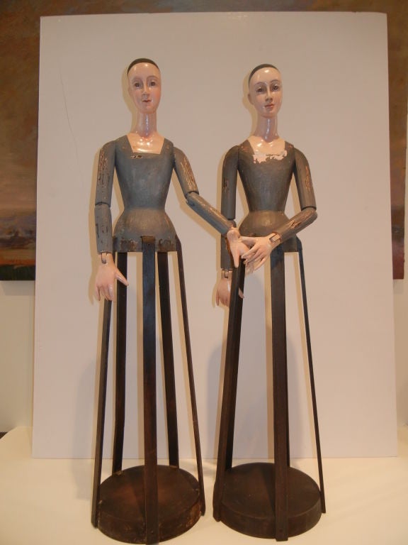 Two tall doll mannequins in dutch dress,the hands and arms all move and stay in place,some paint loss,good vintage condition.