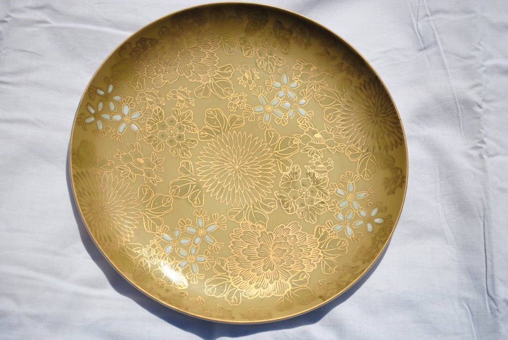 A stunningly beautiful and richly embellished set of Dorothy Thorpe Chrysanthemum pattern. On a matte glazed background of a pale khaki tone. Asian mums,jasmine blossoms of white and fanlike leaves are outlined in hand painted gold.The undersides of