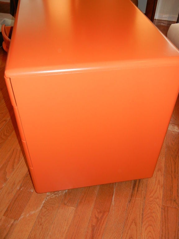 Retro Danish Mid-Century desk. With six pull-out drawers, the left bottom drawer is a two part file drawer as shown in the other images. The color is a deep burnt orange. All sides are finished, so this piece can free stand away from the wall, or be
