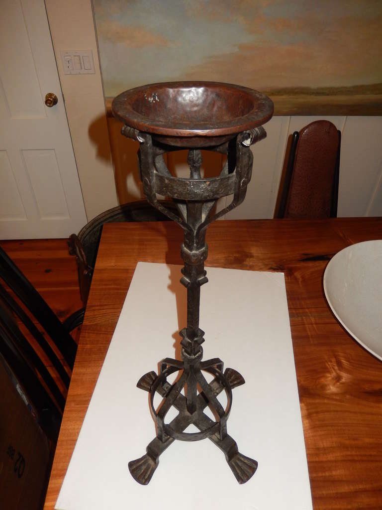 Pair of Arts & Crafts American hand forged standing ashtrays or can be used as candle holders. The ashtray measures 7.5 in diameter, the base measures 14 inches. Well detailed with all of the characteristics of the period, circa 1920.