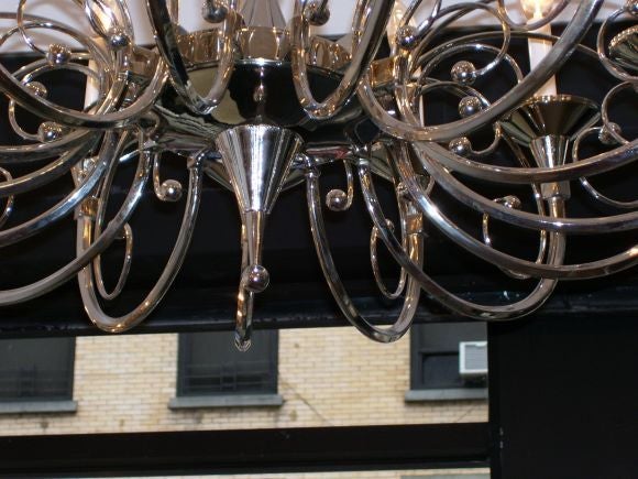 A large French Art Deco, fifteen-armed Chandelier, in a wonderful nickel on brass finish, all in perfect working condition, the chain has 4 foot length plus ceiling cap in nickel. The top has a burst of stick and ball decorative, adding to alot of