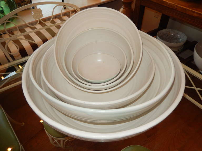 Seven hand crafted white bowls.. Each bowl is made by hand so all are a little different in shape. Also available in smaller groups of pastels, click on to view the other pieces. Measurements listed are for the largest bowl; the smallest bowl is