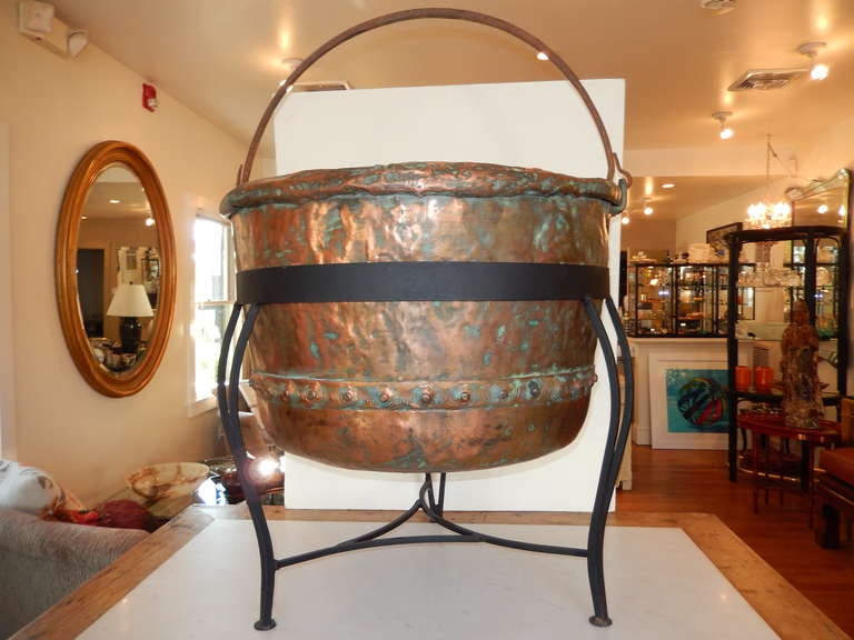 An extraordinary large hand wrought Copper Caldron, hand crafted in the USA, resting on a custom hand wrought black stand. The height listed is from the bottom of stand to top of cauldron and the actual cauldron height is 18