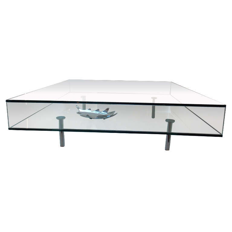 A rare and chic glass and chrome legged coffee table from Milan. Tempered glass, open encasement at two sides.