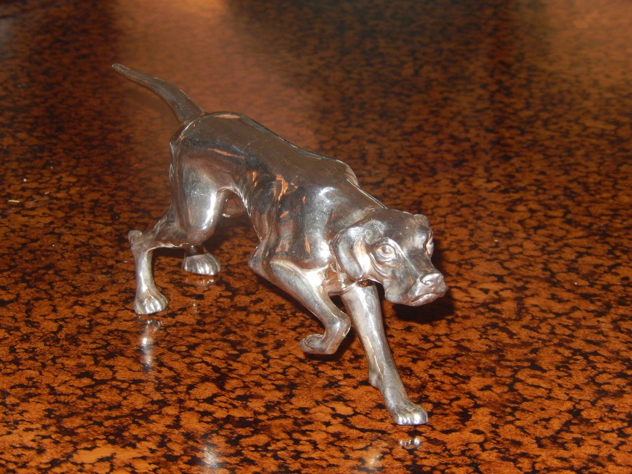 A beautifully executed Art Deco sculpture of a Red Setter in sterling silver 925. The Lenght is 8 inches, the width is 3 inches and the height is 4 inches.
