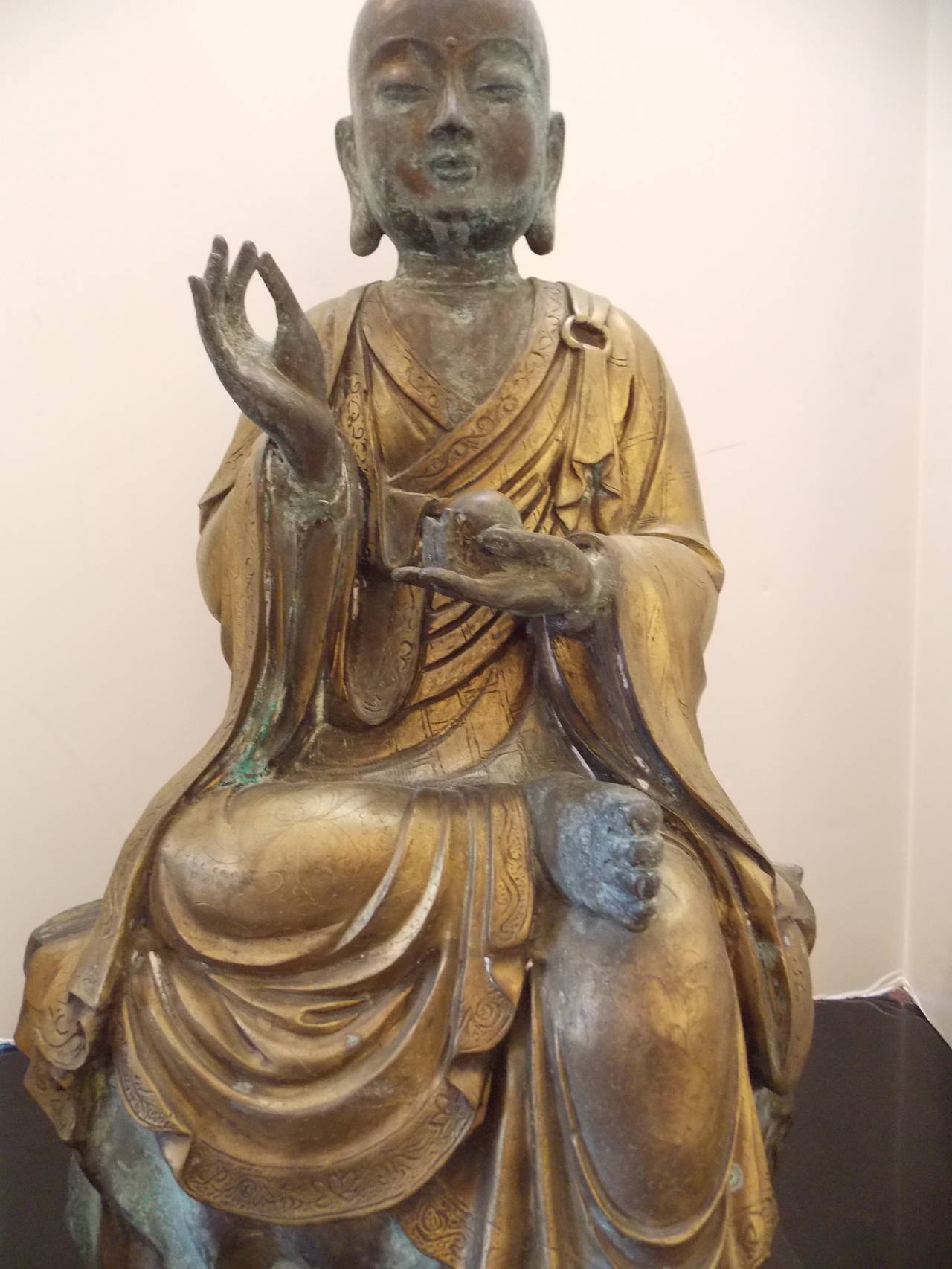 An exceptional large bronze and copper Lohan (Chinese) fine craftsmanship and detail to the hands, face and garment.