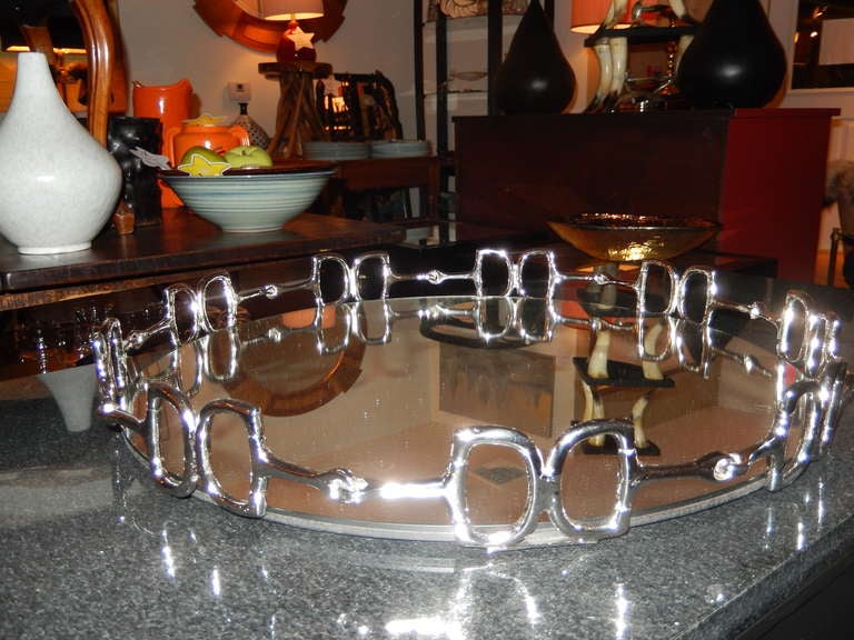 An exceptional large equestrian themed mirrored circular tray.
Finished in a nickel coating over brass. Black felt bottom.