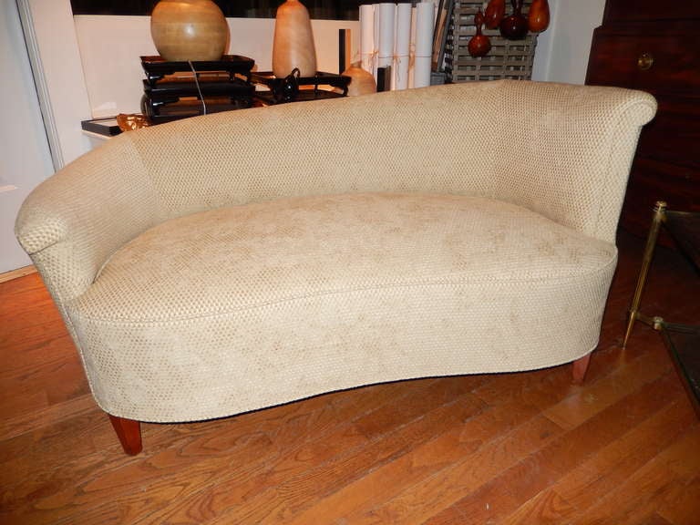 Pair of kidney shaped Baker Love Seats from 1930's. New upholstery in a luxurious Kravet sandy colored chenille fabric.  Cherry wood legs and frame, firm comfort, chic and sexy in shape.