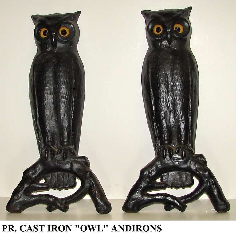 An imposing pair of cast iron tall andirons. Owls perched on a branch,and appearing to be staring right at you, these well detailed and life like owls make a wonderful addition to your fireplace or they can be used as wall décor, as they have a