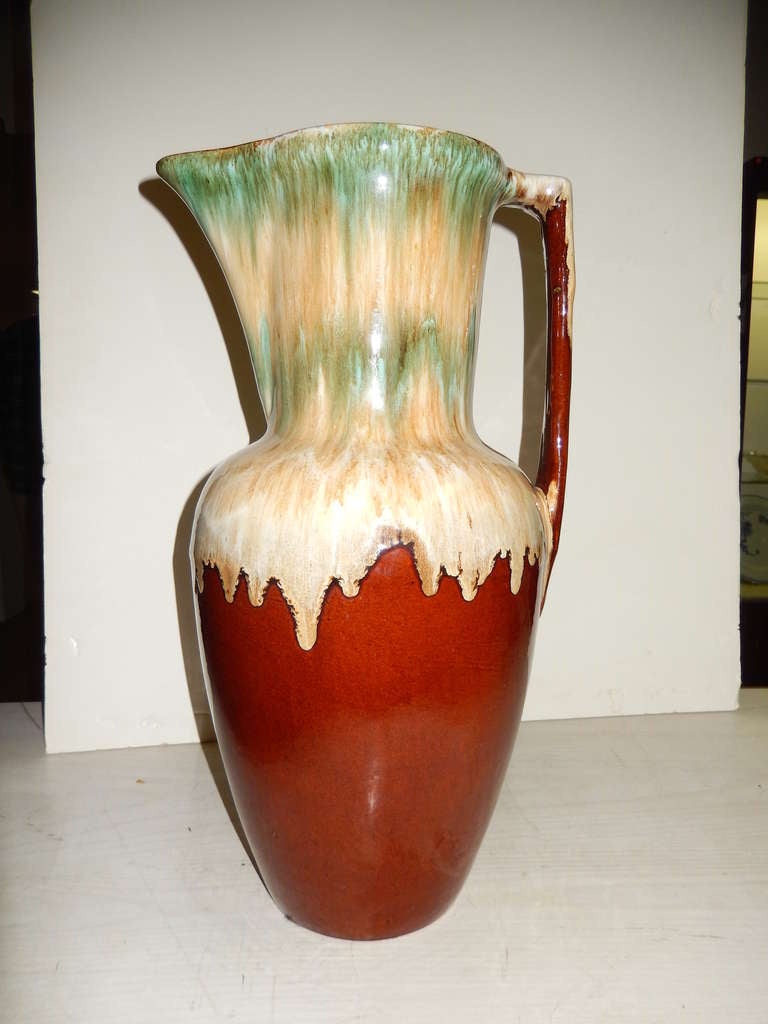 An outstanding piece of Roseville art pottery in a green yellow and cream drip glaze over a deep brown red base.