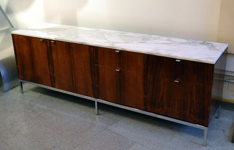 A beautiful rosewood and marble top credenza designed by Florence Knoll for Knoll Associates. A wonderful conservative piece for office or home.