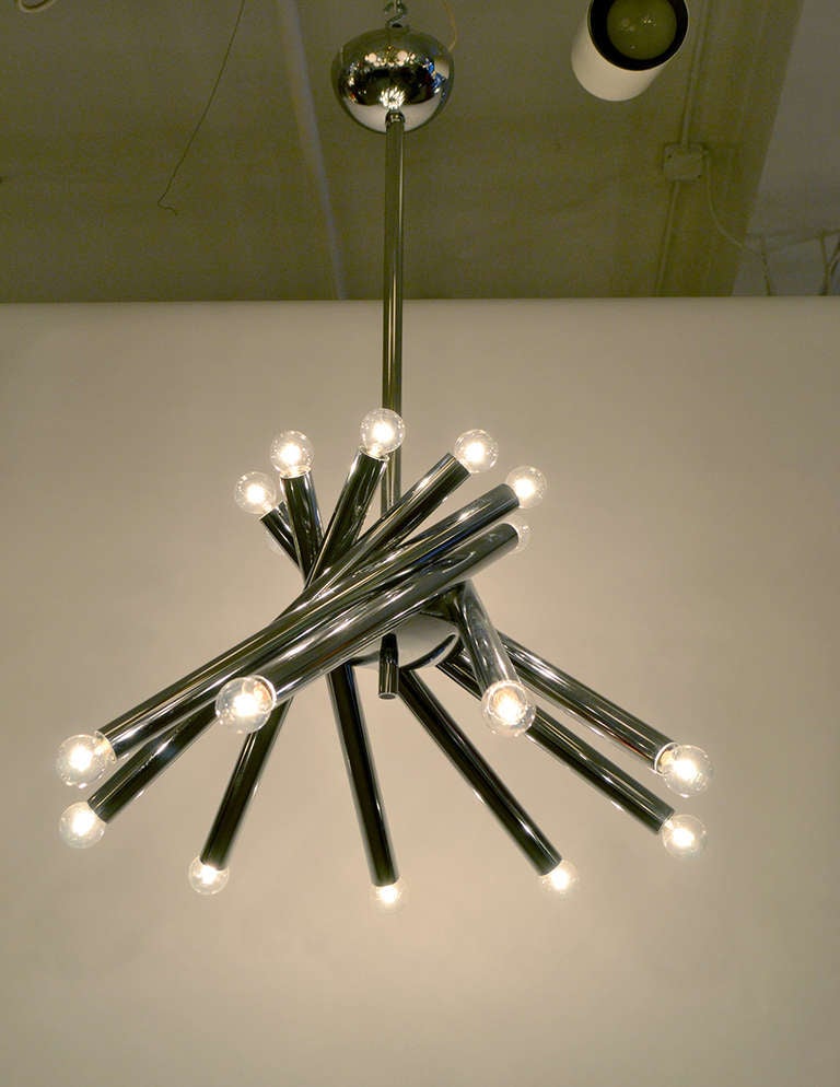 A spiraling candlestick chandelier with 18 bulbs in chrome from Italy.