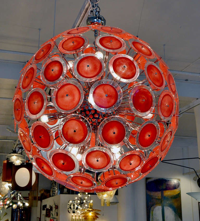 A majestic and spectacular chandelier with Murano disc finials. The chandelier consists of a central chrome ball with dandelion like sprouts; each holding a wonderful Murano glass disc.