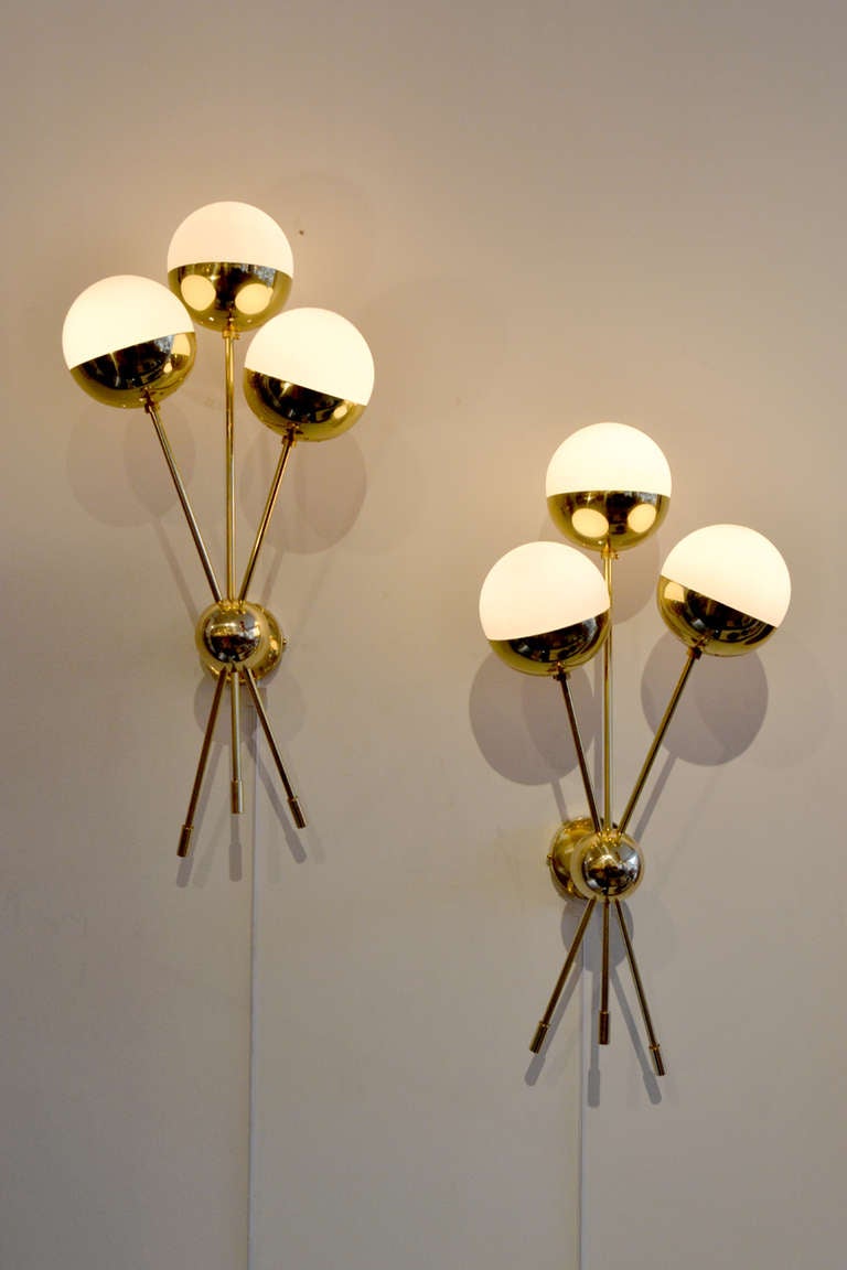 A wonderful pair of sputnik style sconces  These sconces are a modern day reproduction in the manner of Stilnovo lighting, Italy.