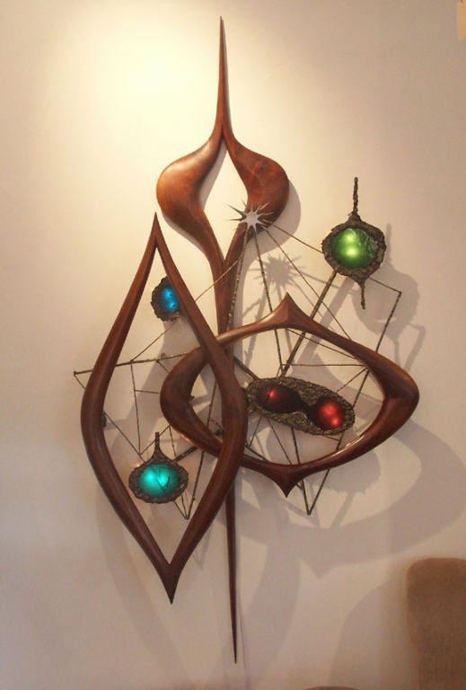 A truly amazing and all original illuminated wall sculpture by Philip Lloyd Powell and Paul Evans. Powell took up residence at his studio in New Hope PA in the late 1940's, and began a decades long career honing his craft as a woodworker and artist.