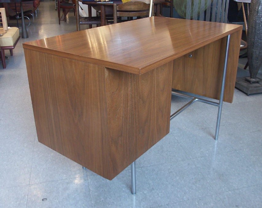 Beautiful example from Nelson's popular designs for Herman Miller. Small scale desk, with a single bank of 3 drawers, each with J pull handle. The top with single drop leaf, considerably expanding the work surface, by use of an invisible cantilever.