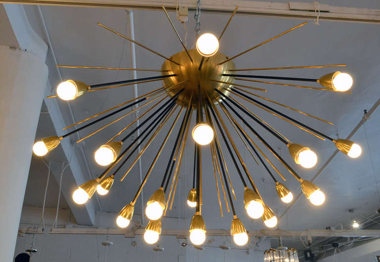 A very dynamic and sizable sputnik chandelier in the style of Stilnovo. The chandelier is comprised of 21 sockets for plenty of light. It is impressive in size without being overwhelmingly glitzy. A wonderful and sophisticated piece.