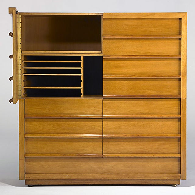 A rare and extremely large storage unit by Robsjohn Gibbings. Top consists of two large doors for enclosed storage and three rows of half-drawers, and one large bottom drawer.